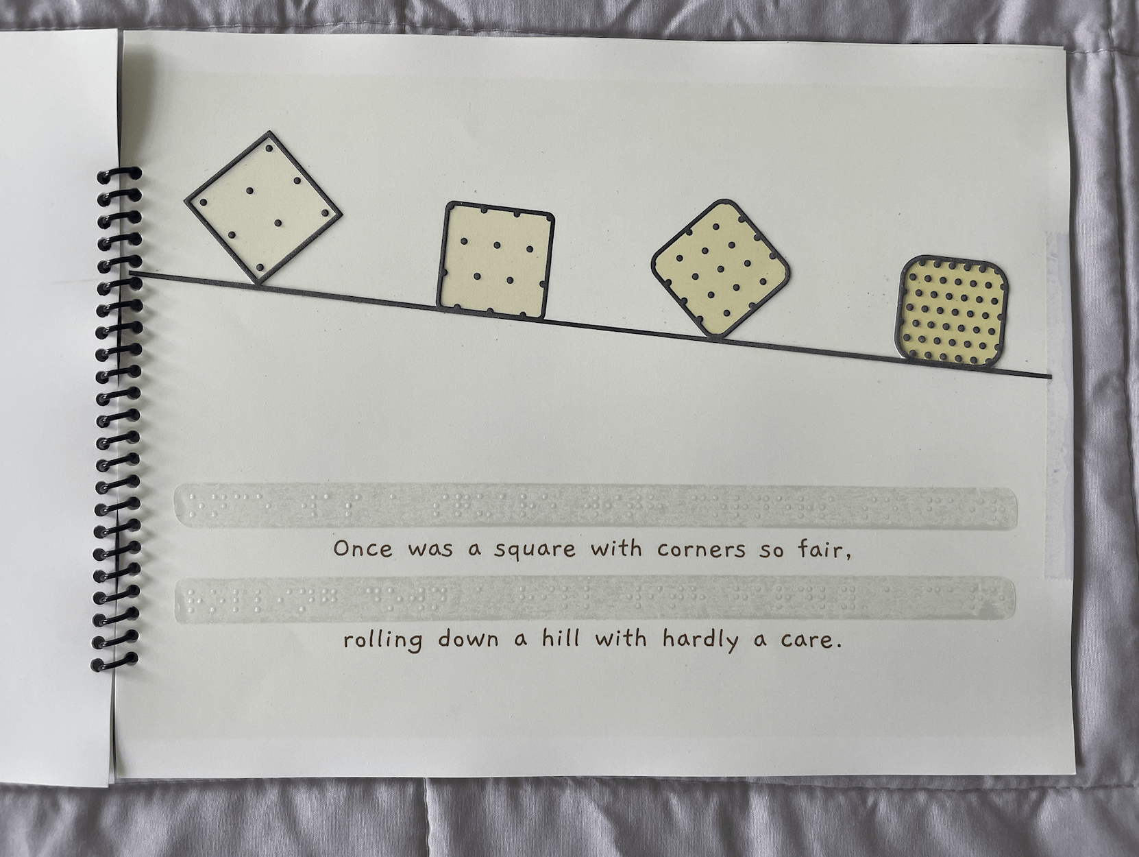 First page in the storybook, showing four yellow squares going down a hill.